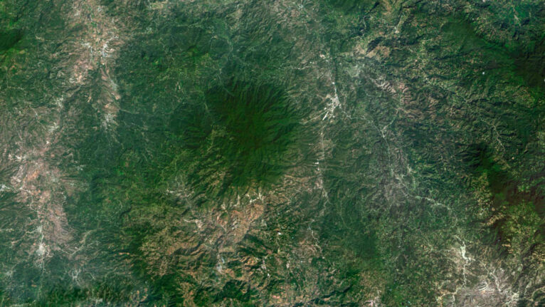 Satellite view of Honduras highlighting coastal regions and mountainous areas.