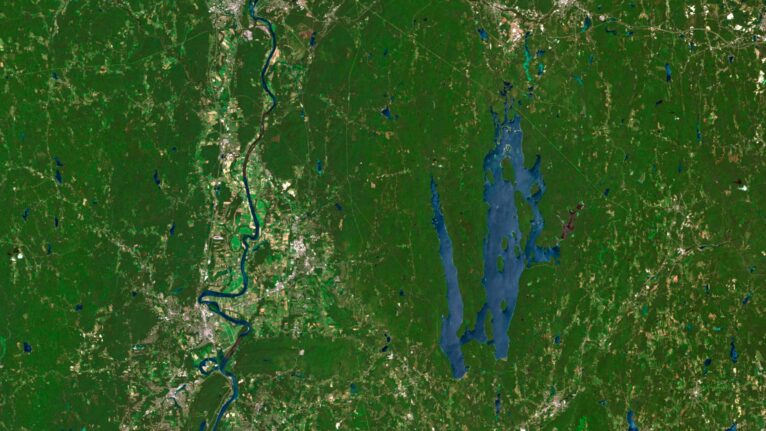 Satellite view of Massachusetts highlighting coastal areas and inland forests.
