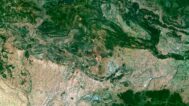 Satellite view of Spain highlighting coastal regions and inland landscapes.